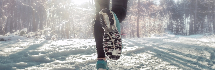 Foot of someone running in snow