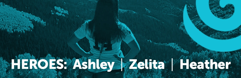 Woman looks out over mountain valley