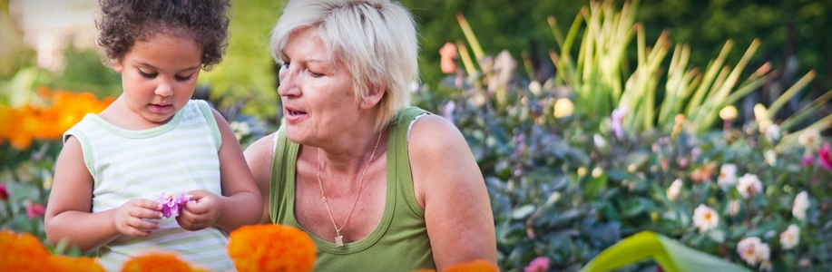 Grandmother in garden with grandchild